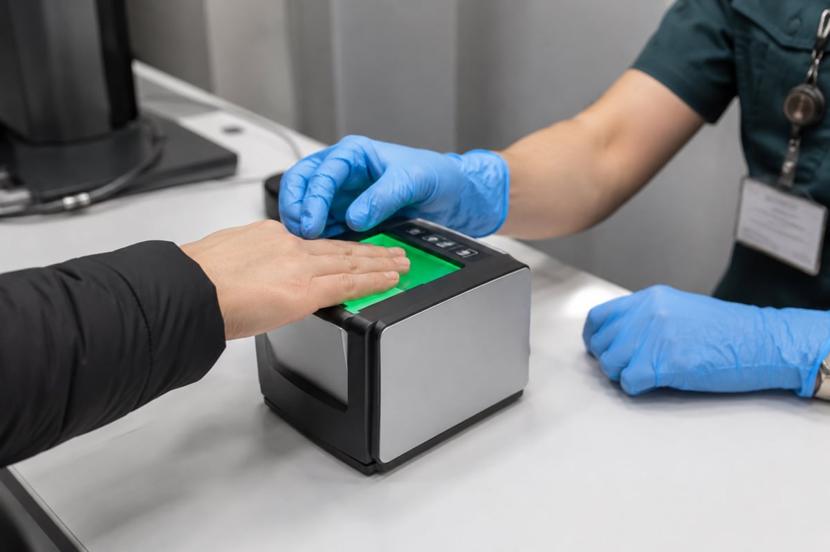 Fingerprint scanning with a biometric scanner for digital identity verification and modern security system, close-up view.