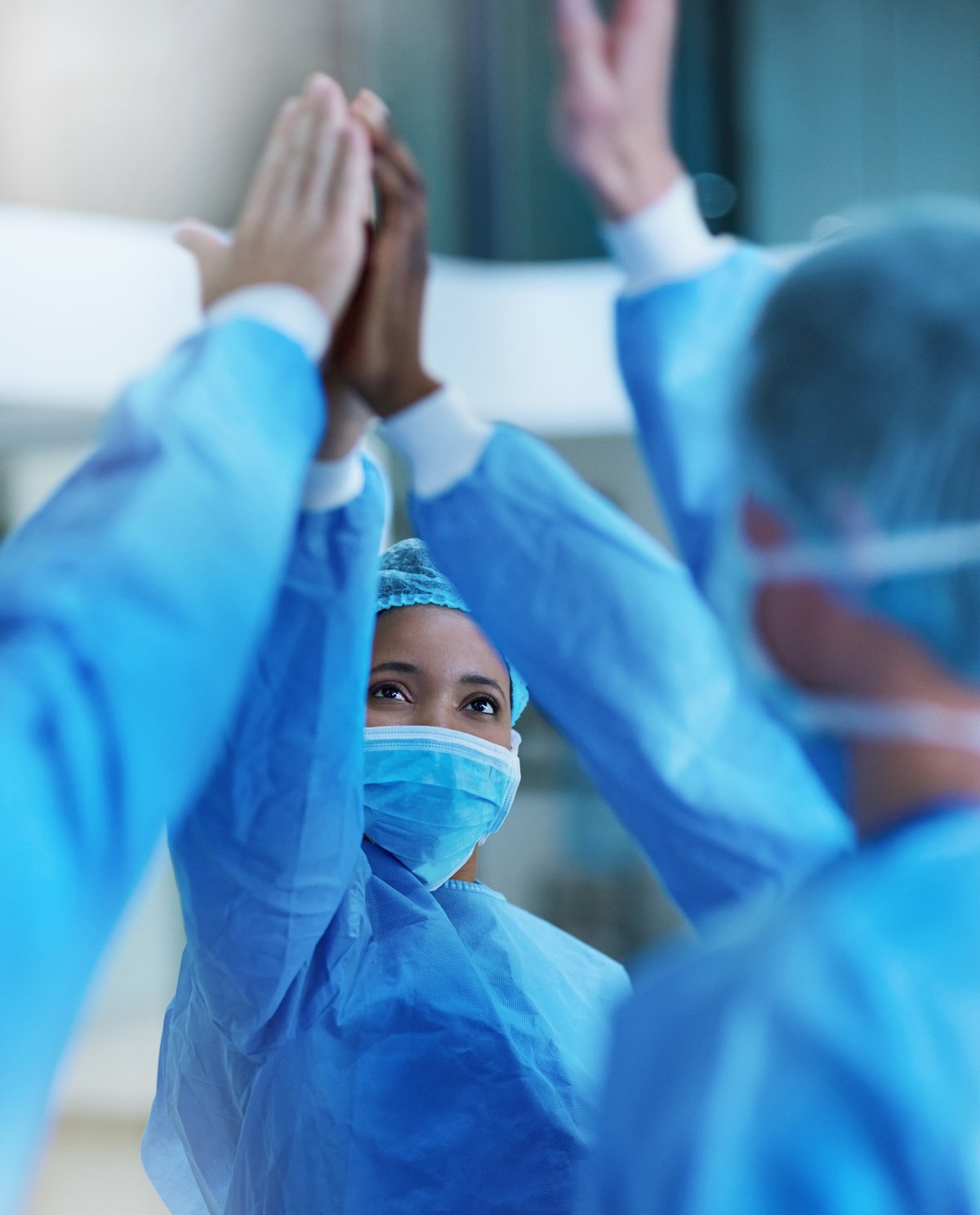 Shot of a team of surgeons giving each other a high five